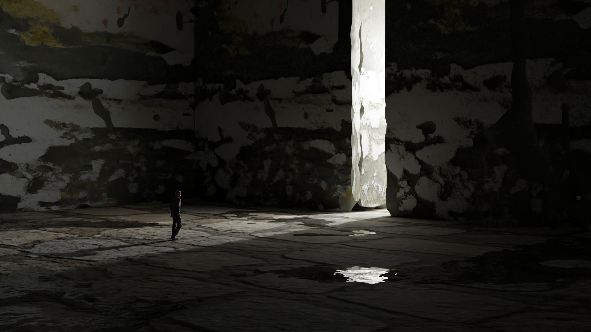 A lone figure in a vast, weathered concrete hall, a single shaft of white light falling through a slit in the wall onto a wet floor
